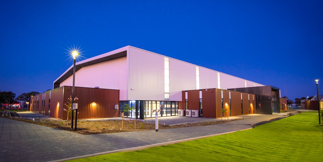 Exterior of gym lit up at dusk