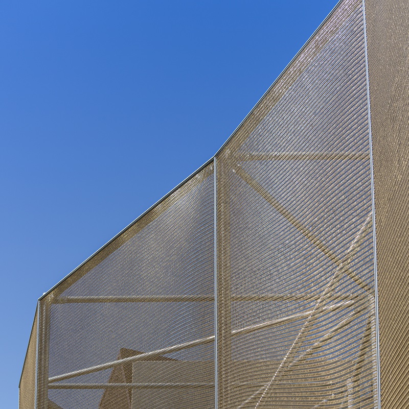 Building facade with steel mesh wrapping the exterior