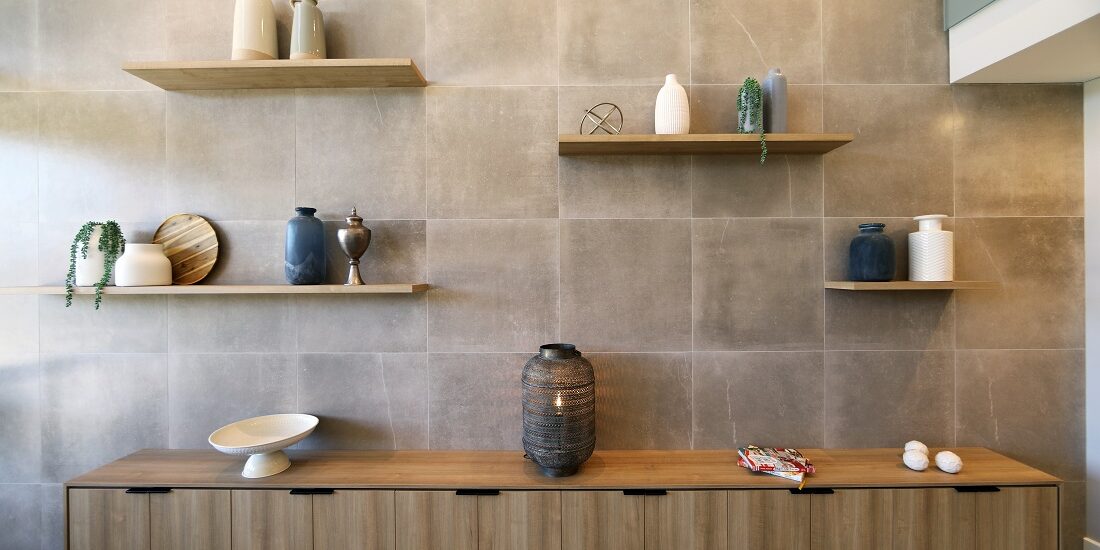 Feature wall with shelving displaying various pots and vessels