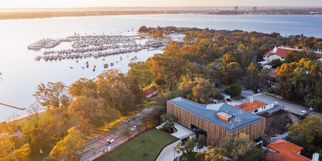 Aerial view of university building and Matilda Bay with marina in the background